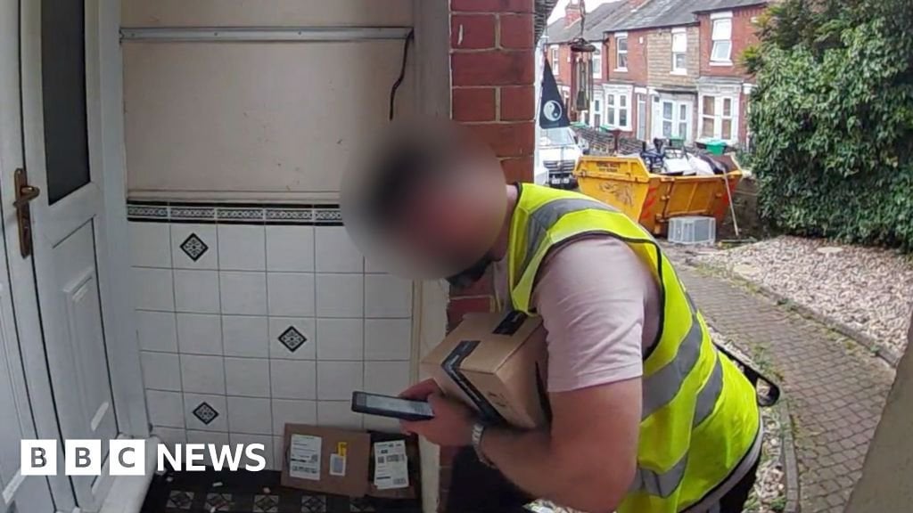 Doorbell camera films Amazon driver taking parcel on doorstep