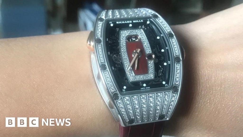 Woman robbed of £185K watch in front of children