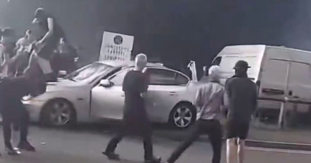 Sickening moment racist mob drag man out of car shouting 'kill them' during riot