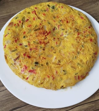 In my house it is with red and green pepper and onion