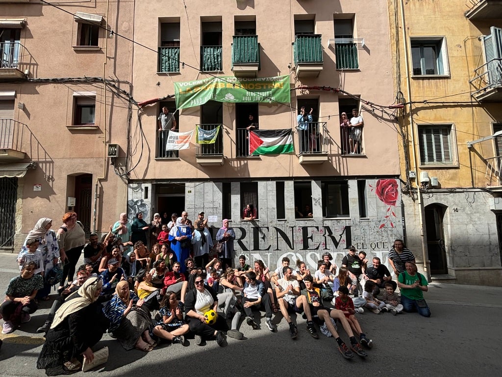 Housing Activists in Spain Occupy Vacant Bank-Owned Buildings and Halt Evictions Members of PAHC sit outside of the reclaimed building where Pablo and Nadia live in Manresa, Catalonia, on May 5, 2024, to celebrate the squat’s one-year anniversary.