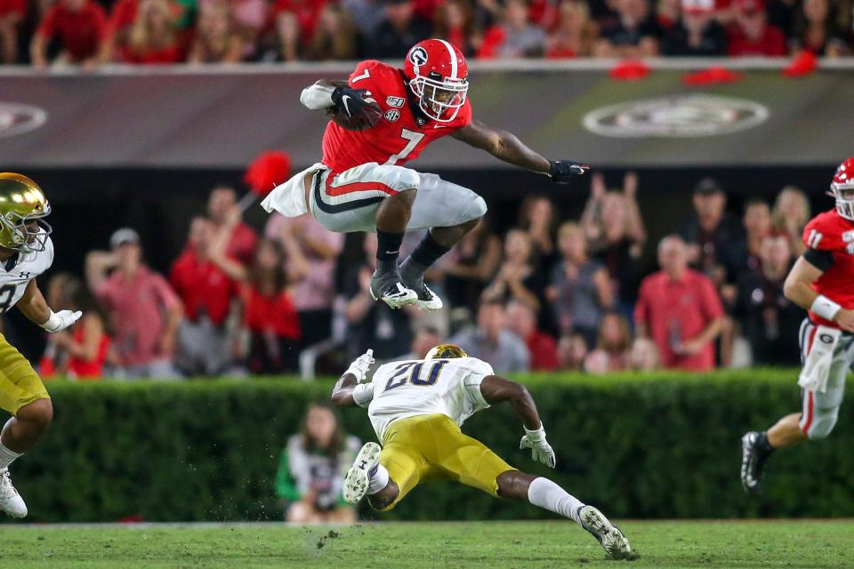 Sep 21, 2019; Athens, GA, USA; Georgia Bulldogs running back D'Andre Swift (7) hurdles Notre Dame Fighting Irish cornerback Shaun Crawford (20) in the third quarter at Sanford Stadium. Mandatory Credit: Brett Davis-USA TODAY Sports