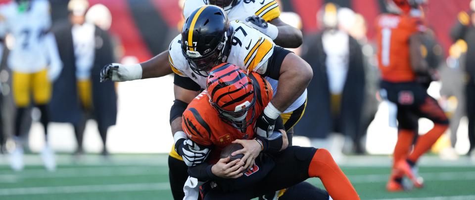 CINCINNATI, OHIO - DECEMBER 01: Joe Burrow #9 of the Cincinnati Bengals is tackled by Cameron Heyward #97 of the Pittsburgh Steelers during the third quarter at Paycor Stadium on December 01, 2024 in Cincinnati, Ohio. (Photo by Dylan Buell/Getty Images)