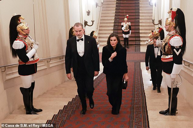 To wrap up warm for the outside, Letizia had a matching black coat to complement her gown on Wednesday evening