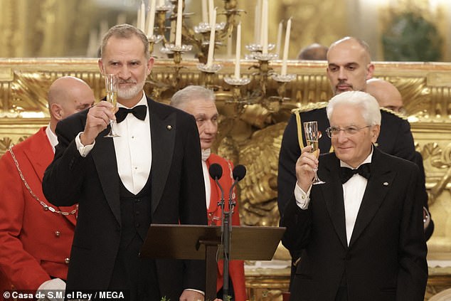 The royal stunned in the simply elegant monochrome dress as she and King Felipe VI (left) were welcomed by Sergio Mattarella (right) at the Quirinal Palace during their state visit to the nearby European nation