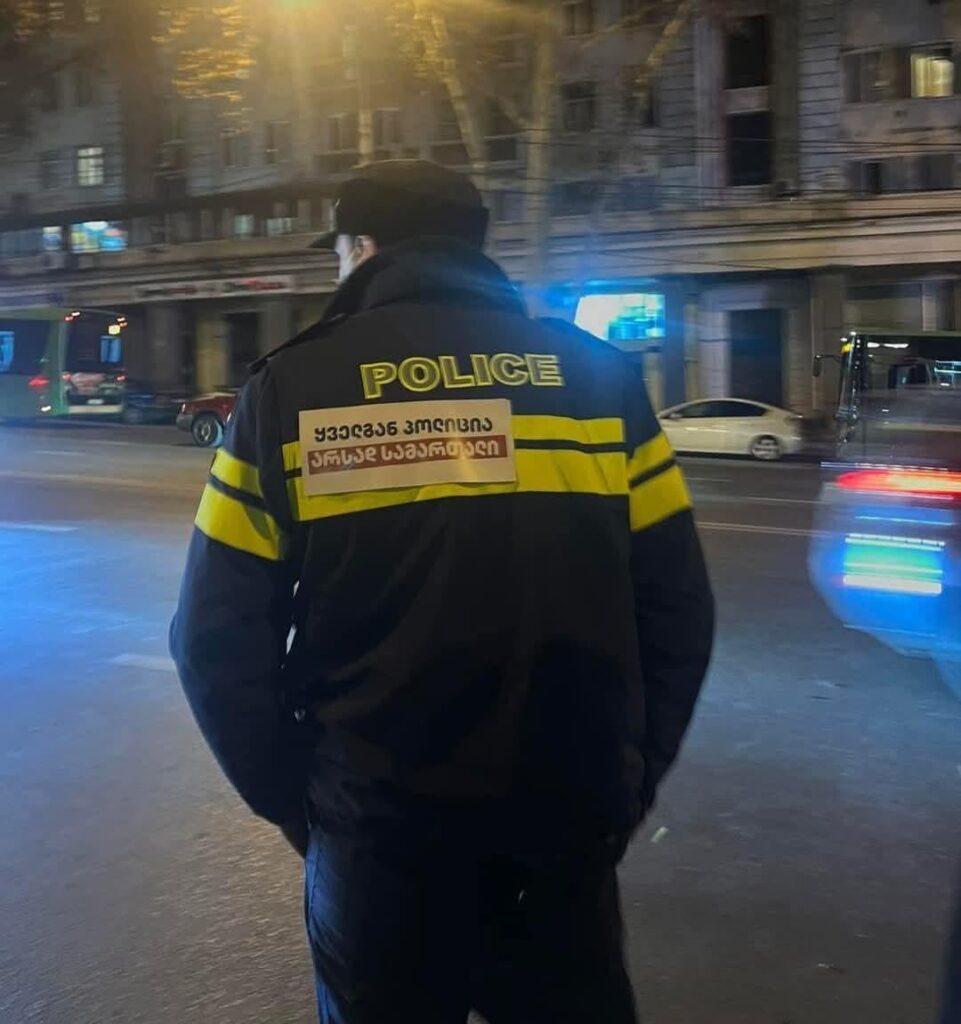 "Police everywhere, justice nowhere" - Someone put the sticker on a policeman
