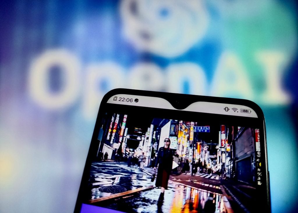 A smartphone screen displaying a vibrant urban street scene with neon lights, set against a blurred background featuring the OpenAI logo.