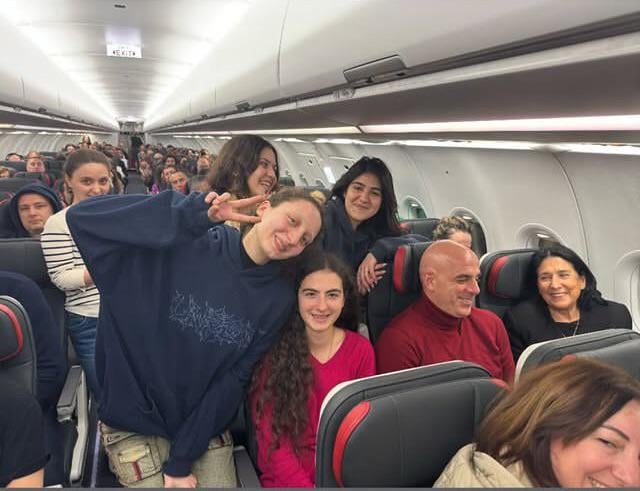 Salome flies back from Paris economy class