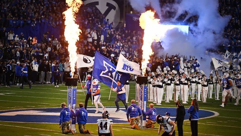 The BYU Cougars run onto the field ahead of their game against Oklahoma State at LaVell Edwards Stadium in Provo on Friday, Oct. 18, 2024.