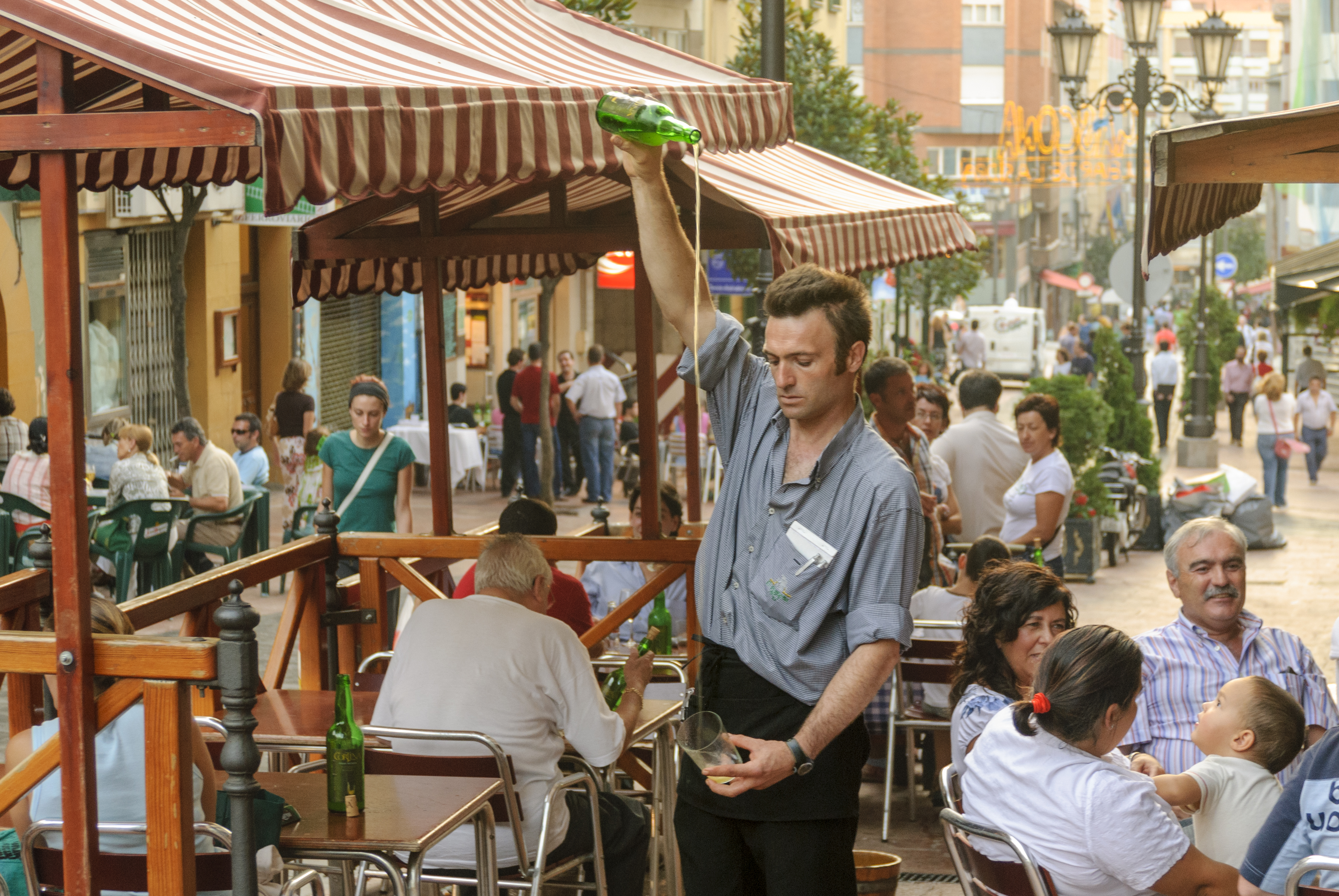 Barman pouring cider in Oviedo, Spain.