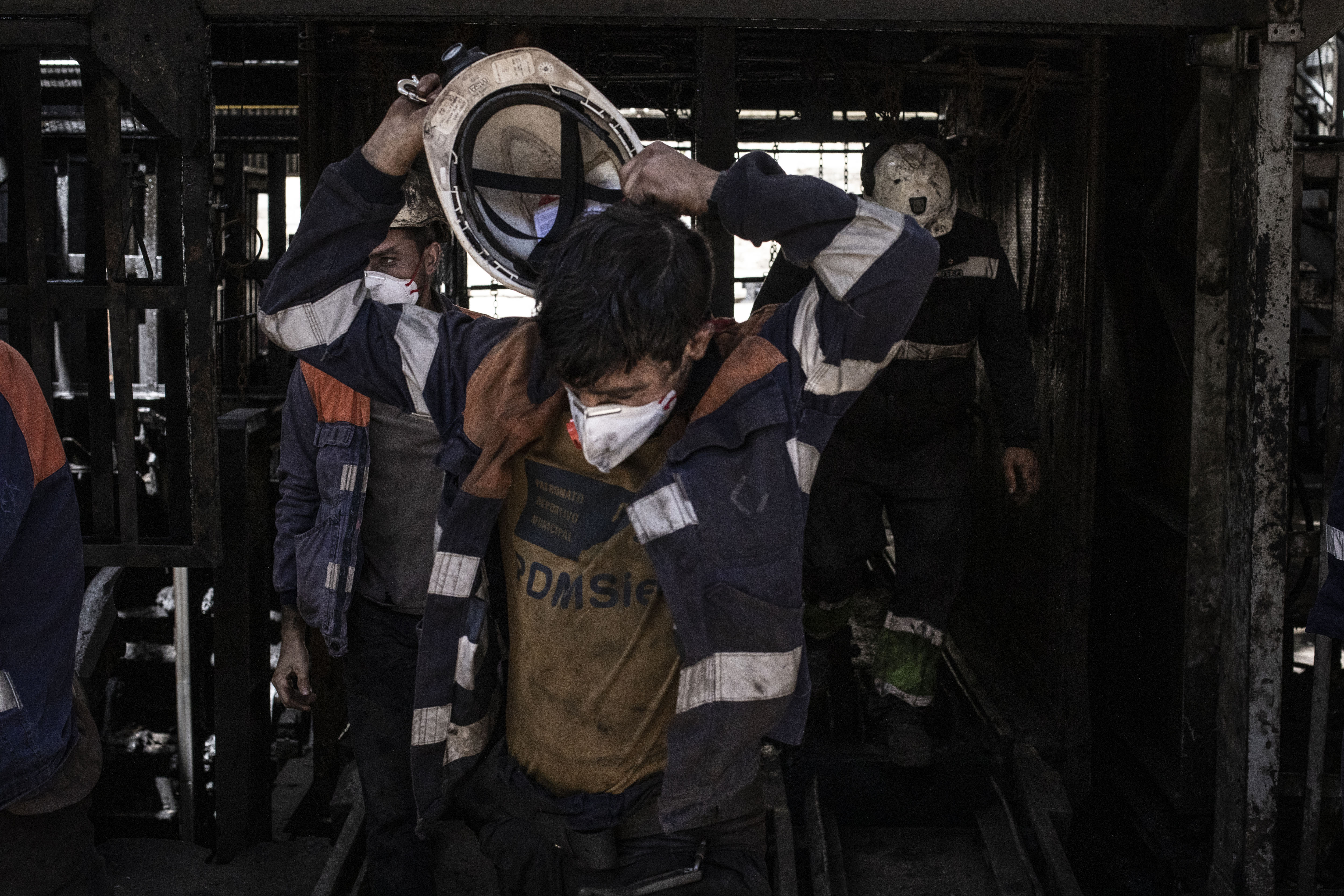 Miners exiting a coal mine elevator.