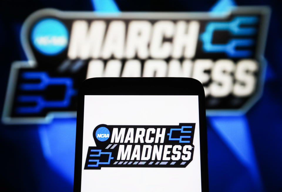 UKRAINE - 2024/04/09: In this photo illustration, a March Madness (NCAA Division I men's basketball tournament) logo is seen on a smartphone and a pc screen. (Photo Illustration by Pavlo Gonchar/SOPA Images/LightRocket via Getty Images)