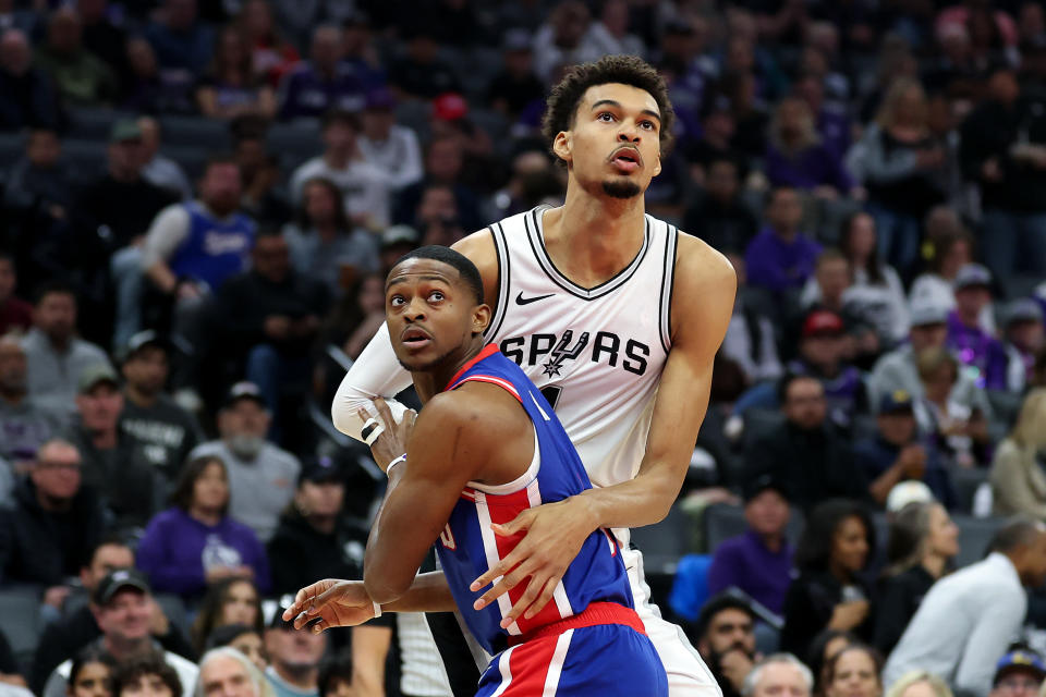 SACRAMENTO, CALIFORNIA - DECEMBER 01: Victor Wembanyama #1 of the San Antonio Spurs and De'Aaron Fox #5 of the Sacramento Kings go for a rebound in the first half at Golden 1 Center on December 01, 2024 in Sacramento, California. NOTE TO USER: User expressly acknowledges and agrees that, by downloading and/or using this photograph, user is consenting to the terms and conditions of the Getty Images License Agreement. (Photo by Ezra Shaw/Getty Images)