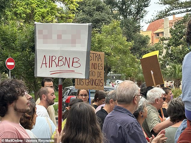 A sign reads'F*** AirBnB', expressing frustration with the holiday home rental company