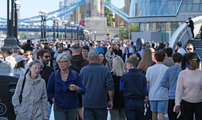 London, United Kingdom, September 14, 2024. Large crowds or numbers of incidental people, tourists, visitor, walking on River Thames Southbank near Tower Bridge. Sunny summer autumn day outdoors.
