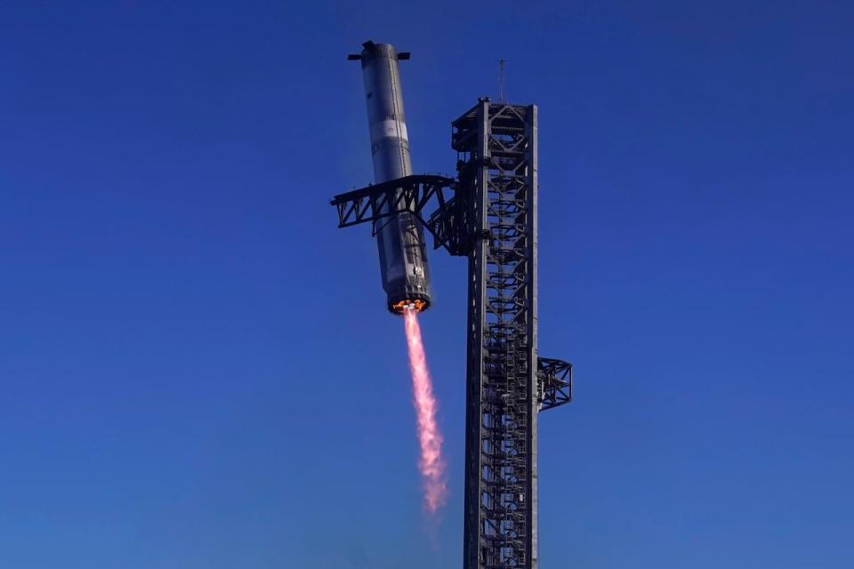 SpaceX's mega rocket Starship booster returns to the launch pad during a test flight from Starbase in Boca Chica, Texas, Thursday, Jan. 16, 2025.