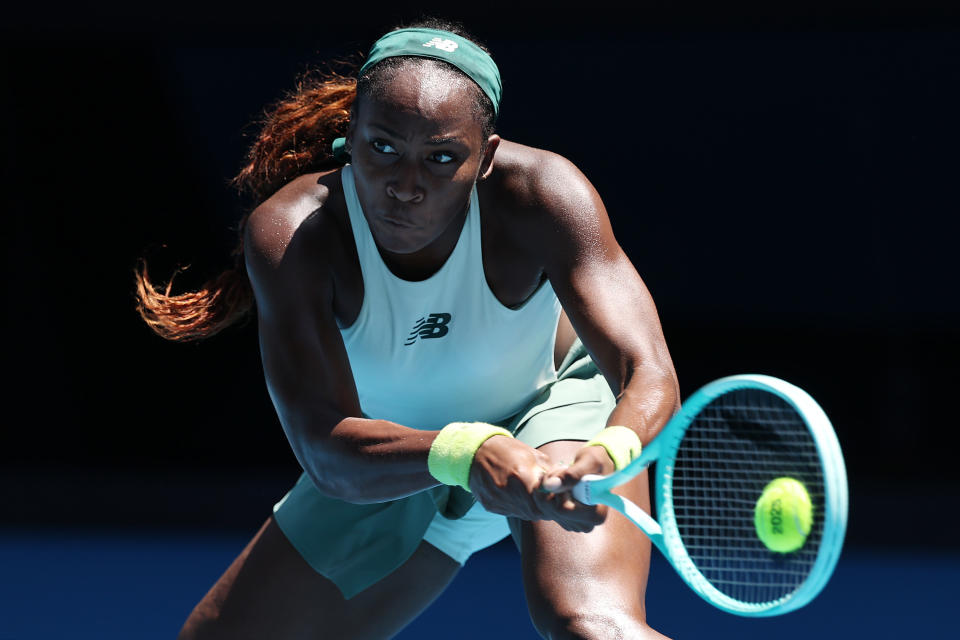 MELBOURNE, AUSTRALIA - JANUARY 13: Coco Gauff of the United States plays a backhand against Sofia Kenin of the United States in the Women's Singles First Round match during day two of the 2025 Australian Open at Melbourne Park on January 13, 2025 in Melbourne, Australia. (Photo by Cameron Spencer/Getty Images)