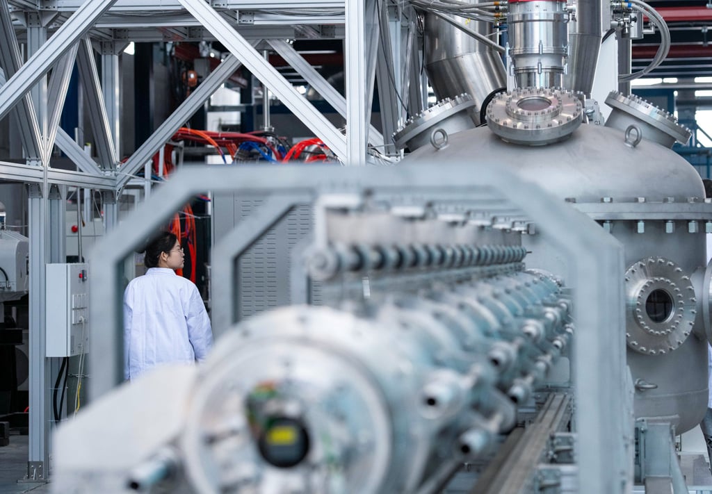 A researcher inspects China’s superconducting linear plasma device “Crimson Skyblade”. Photo: Xinhua
