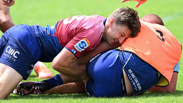 Beauden Barrett makes a tackle in training.