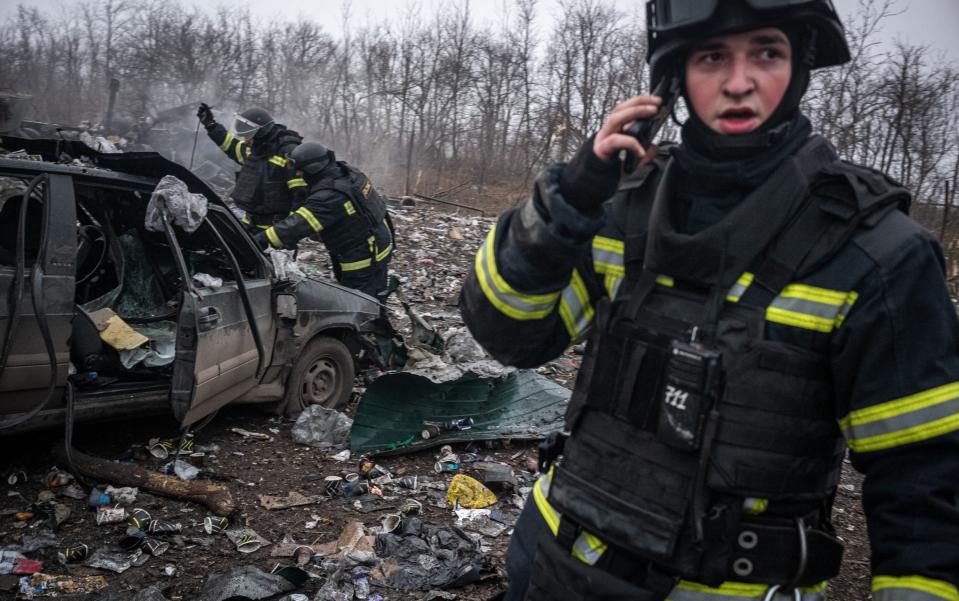 Firemen walk around the site of a Russian missile strike in Pokrovsk, Ukraine