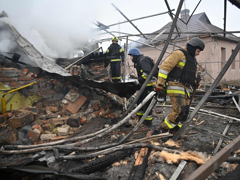 Rescuers worked at the smouldering ruins of a private residence after a Russian drone strike in Kharkiv, Ukraine, on 25 December 2024.