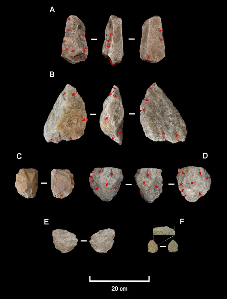 Stone tools against a black background
