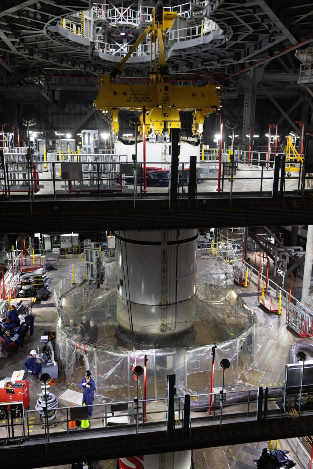 Teams stacking right booster segment four out of five on the Artemis II Space Launch System [Credit: NASA/Kim Shiflett]
