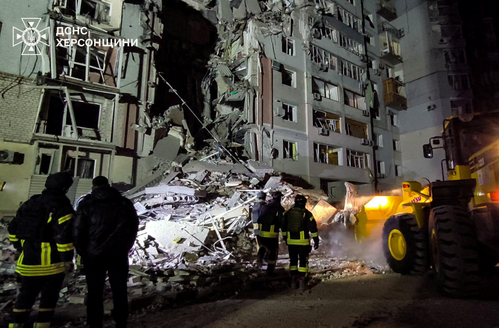 Rescuers at the site of a damaged residential building in Kherson, Ukraine, after a Russian air strike.