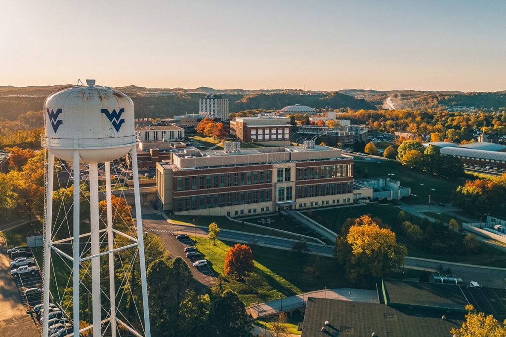 A photo from the air shows the WVU Evansdale area of campus with the water tower in the foreground.