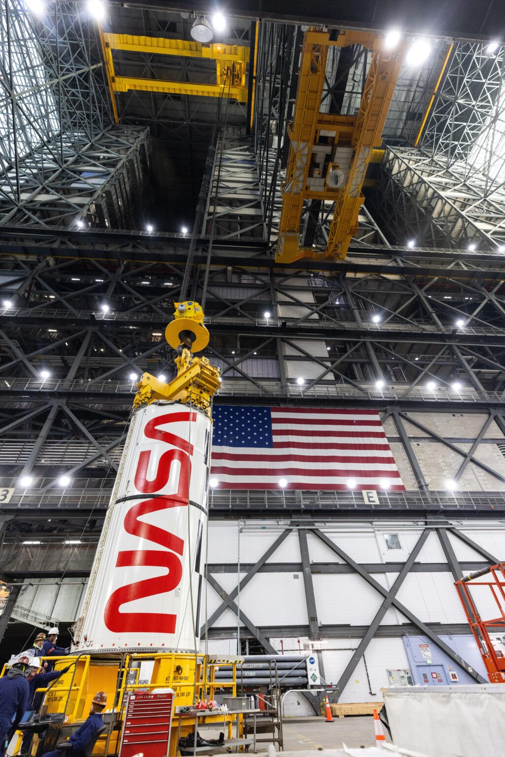 Stacking the left center center booster segment on the Artemis II Space Launch System [Credit: NASA/Frank Michaux]