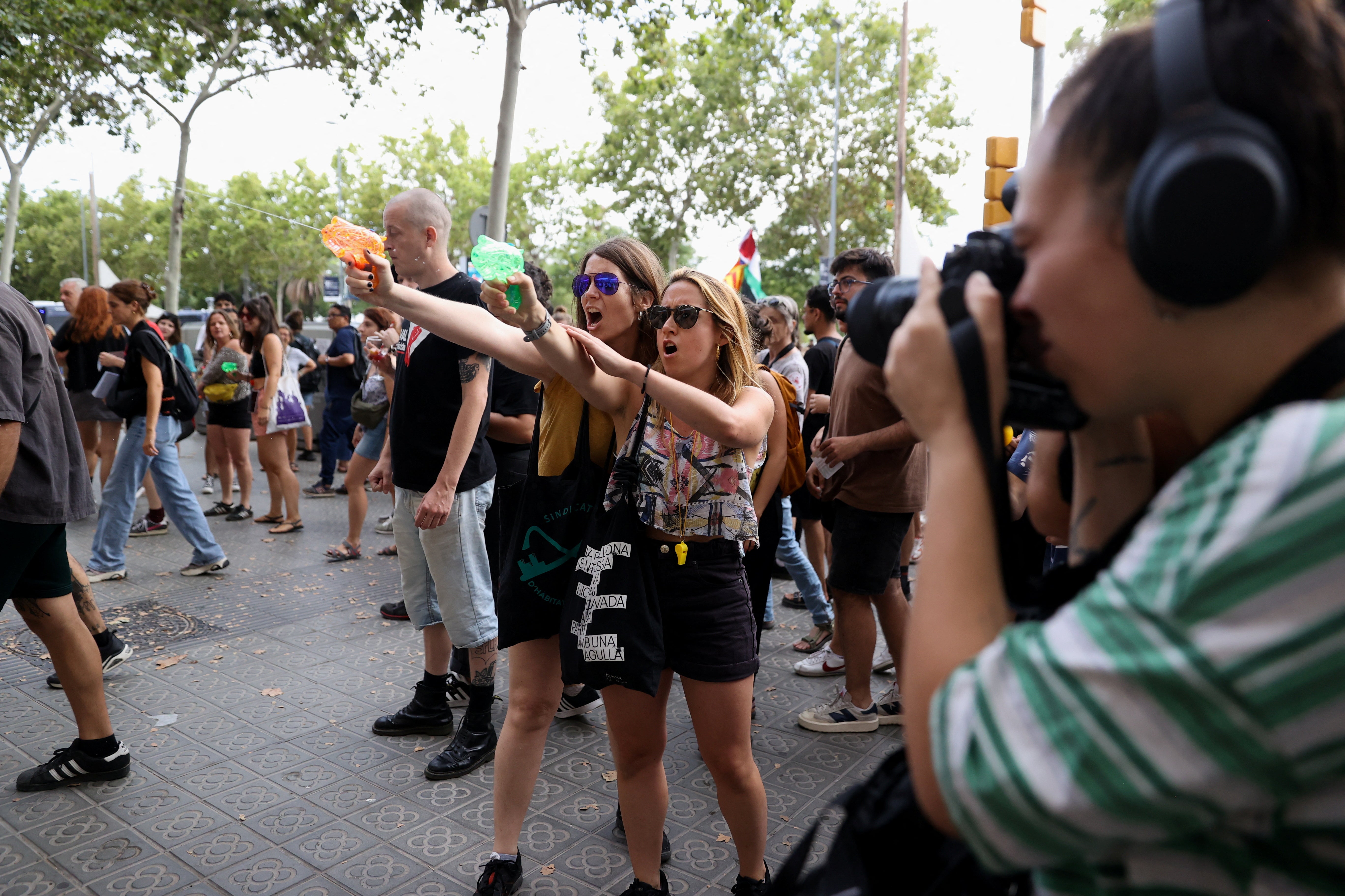 Protesters shoot water from water guns at tourists during a protest against mass tourism in Barcelona, Spain, July 6, 2024