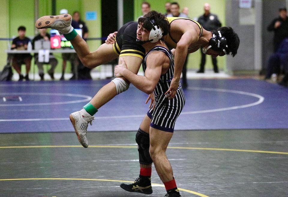 Birmingham's Arno Vardanyan body slams San Fernando's Jorge Palacios in the 126-pound final on Saturday.