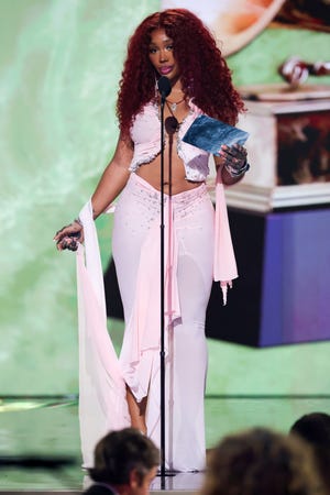SZA presents the best pop duo/group performance trophy during the 67th annual GRAMMY Awards at Crypto.com Arena on Feb. 2, 2025, in Los Angeles.