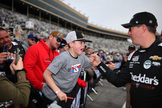 HAMPTON, GEORGIA - FEBRUARY 23: Kyle Busch, driver of the #8 Cheddar's Scratch Kitchen Chevrolet, interacts with a young NASCAR fan prior to the NASCAR Cup Series Ambetter Health 400 at Atlanta Motor Speedway on February 23, 2025 in Hampton, Georgia. (Photo by Jonathan Bachman/Getty Images)