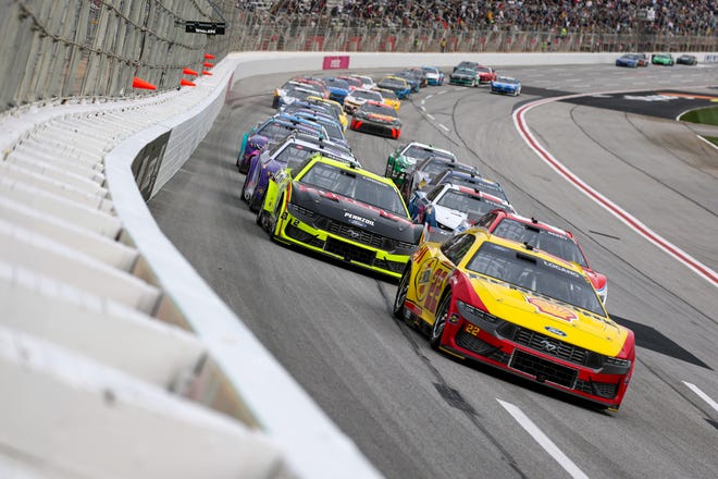 HAMPTON, GEORGIA - FEBRUARY 23: Joey Logano, driver of the #22 Shell Pennzoil Ford, and Austin Cindric, driver of the #2 Menards/Delta Ford, race during the NASCAR Cup Series Ambetter Health 400 at Atlanta Motor Speedway on February 23, 2025 in Hampton, Georgia. (Photo by Chris Graythen/Getty Images)