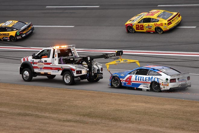 HAMPTON, GEORGIA - FEBRUARY 23: The #4 TitleMax Ford, driven by Noah Gragson is towed after an on-track incident the NASCAR Cup Series Ambetter Health 400 at Atlanta Motor Speedway on February 23, 2025 in Hampton, Georgia. (Photo by Jonathan Bachman/Getty Images)