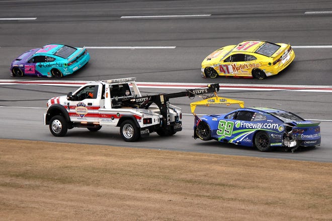 HAMPTON, GEORGIA - FEBRUARY 23: The #99 Freeway Insurance Chevrolet, driven by Daniel Suarez is towed after an on-track incident during the NASCAR Cup Series Ambetter Health 400 at Atlanta Motor Speedway on February 23, 2025 in Hampton, Georgia. (Photo by Jonathan Bachman/Getty Images)