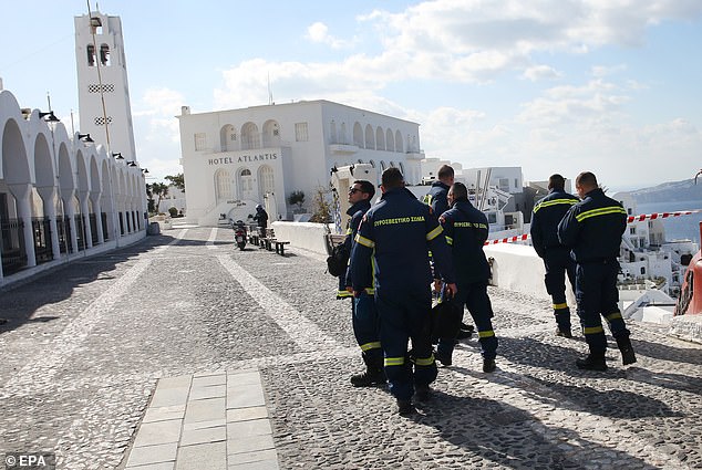Firefighters walk in the almost evacuated village of Fira in Santorini, Greece, 06 February 2025