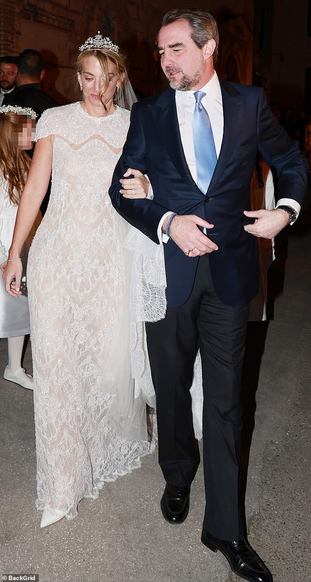 Prince Nikolaos (pictured, right) with his new bride Chrysí Vardinogianni (pictured, left) following their intimate wedding ceremony on Friday