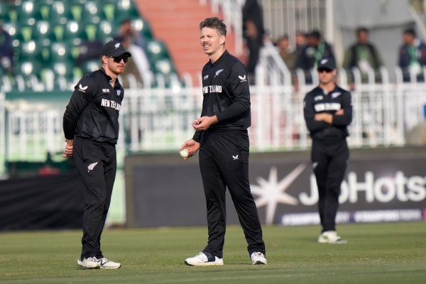 New Zealand's Michael Bracewell, center, chats with Glenn Phillips during the Champions  match against Bangladesh. (AP)