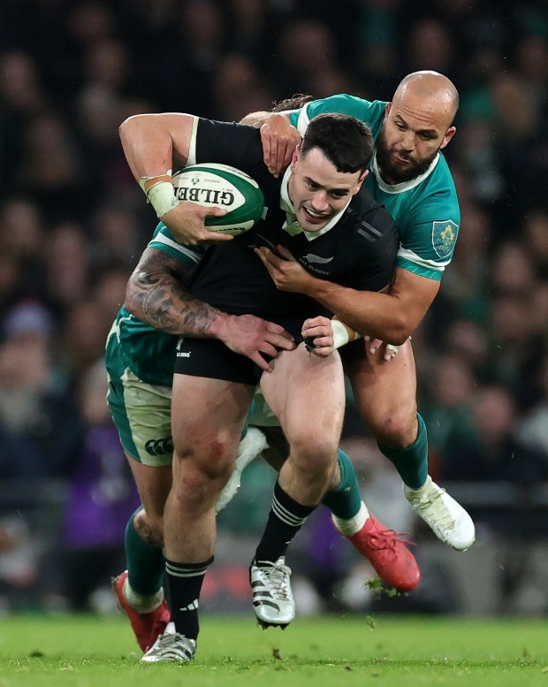 Will Jordan of the New Zealand All Blacks is held by Jamison Gibson-Park, right, and Andrew Porter during the Autumn Nations Series 2024 match between Ireland and New Zealand All Blacks at Aviva Stadium on Nov. 8, 2024 in Dublin, Ireland. (David Rogers/Getty)