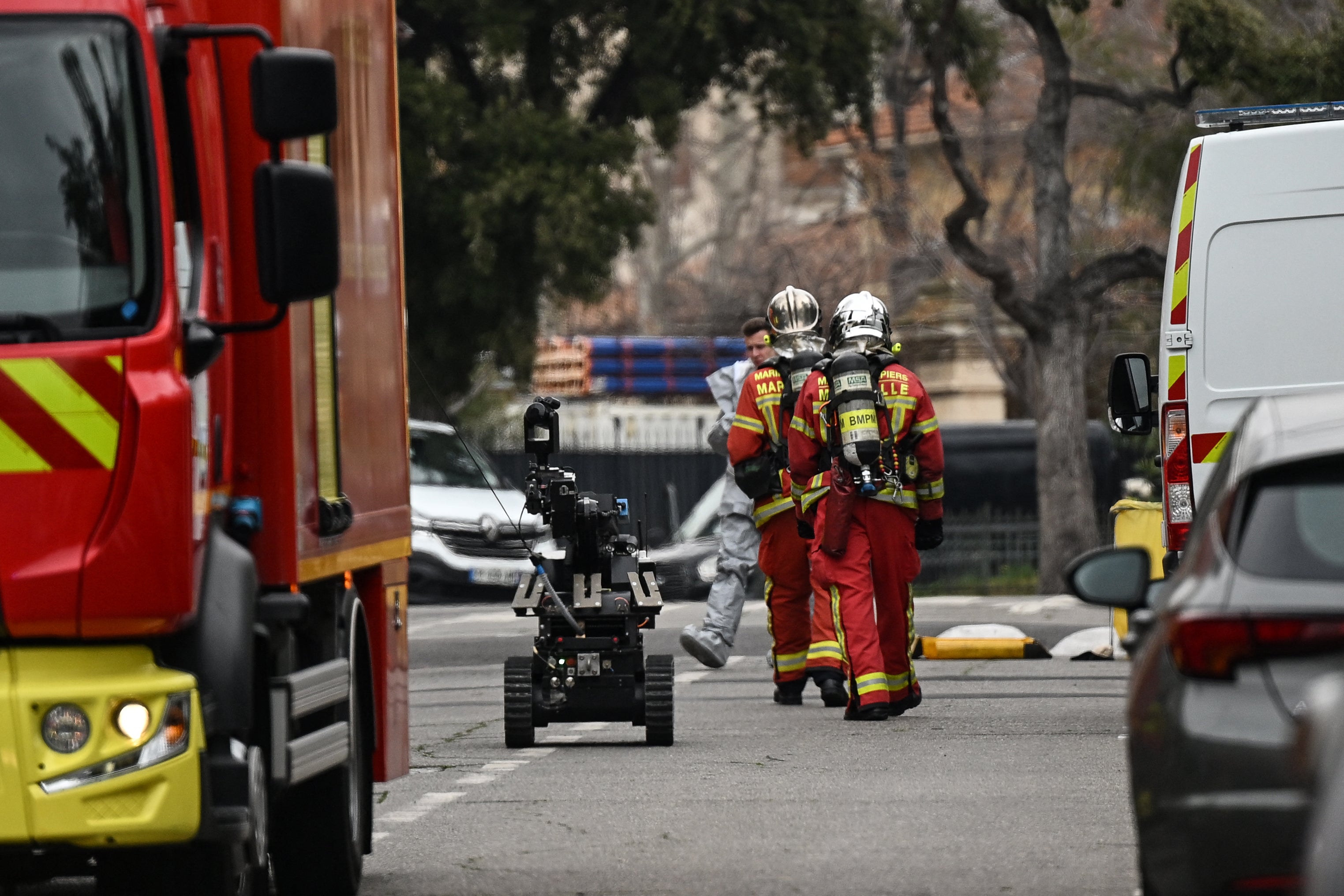 Members of Marseille Naval Fire Battalion (Marins-Pompiers de Marseille) arrive with a demining robot in front of the Russian consulate in Marseille,