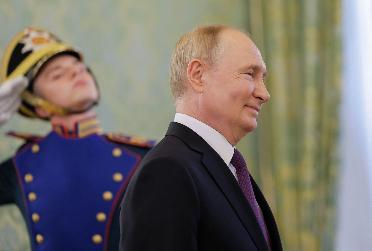 Vladimir Putin walks past an honour guard at the Kremlin in Moscow on July 31, 2024. 