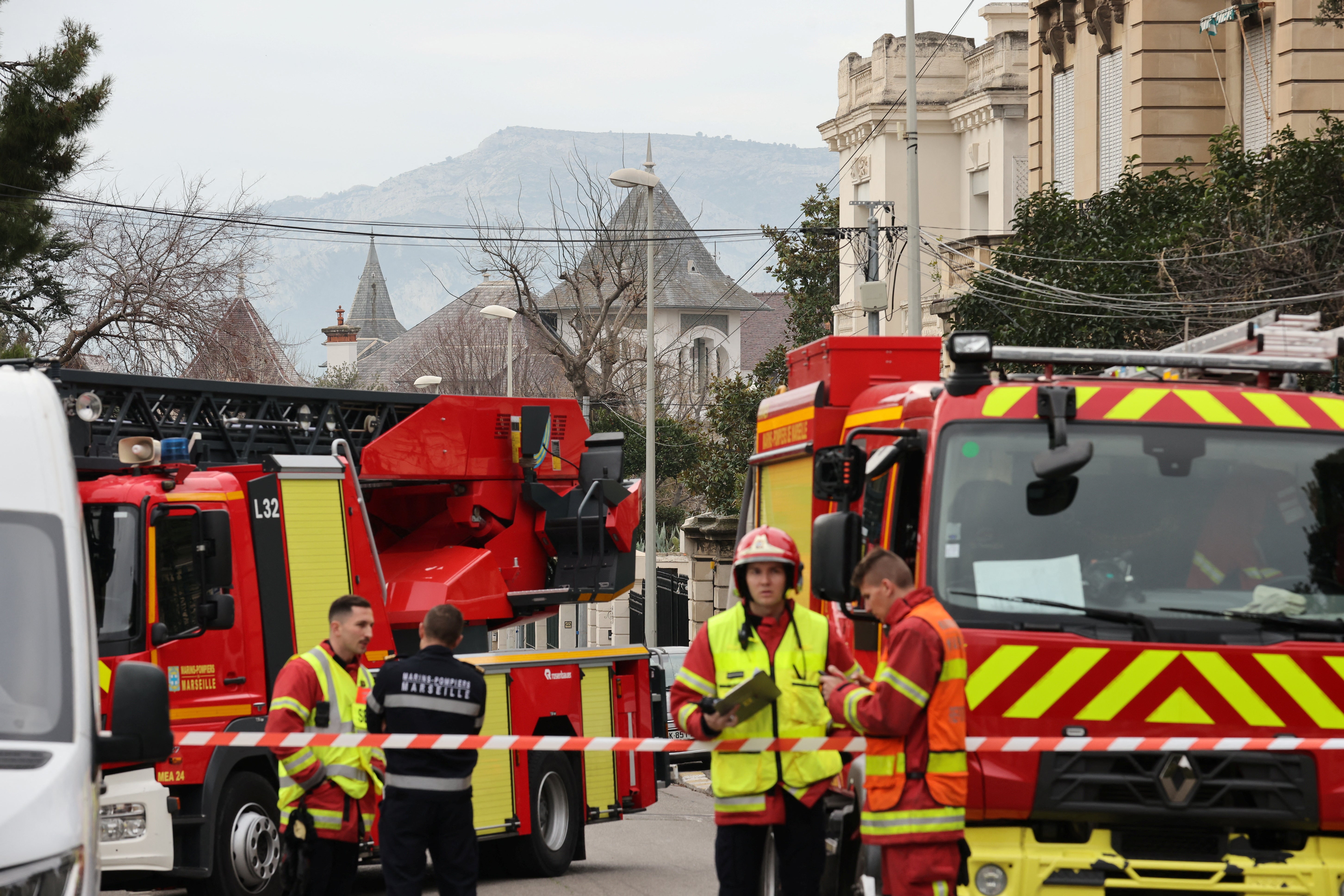 French firefighters and rescue forces stand near the entrance of the Russian consulate in Marseille