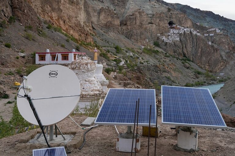 Solar panels and internet dish on a guest house roof at Phuktal Gompa, Zanskar, Ladakh. Decentralised renewable energy received a boost with an 80% rise in PM Surya Ghar: Muft Bijli Yojana’s allocation. Image: Timothy A. Gonsalves via Wikimedia Commons (CC-BY-SA-4.0).
