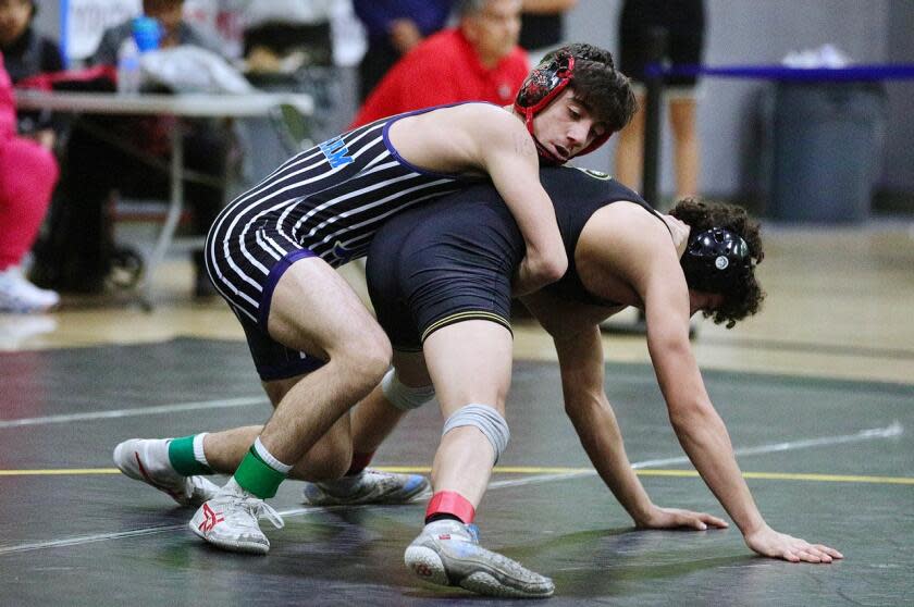 Bimirngham junior Henry Aslikyan wraps up San Fernando's Matthew Gonzalez.