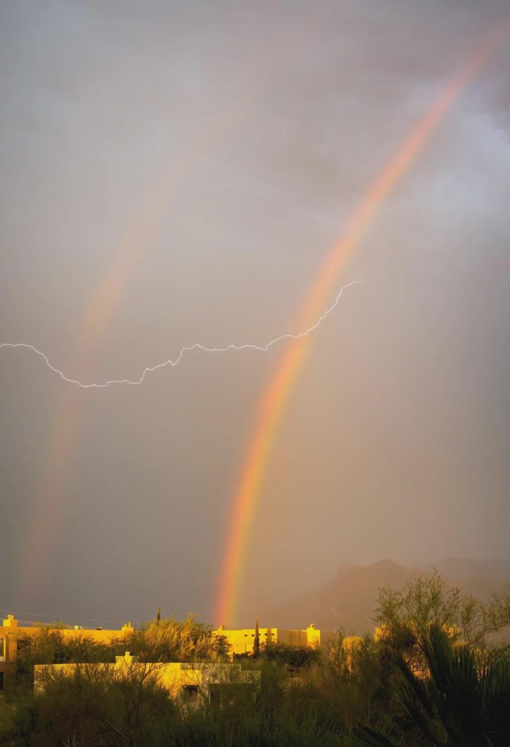 Lightning through a Double Rainbow in Spain