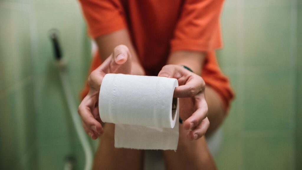 Experts Reveal What Your Bowel Movements Mean for Your Health A person sitting on a toilet