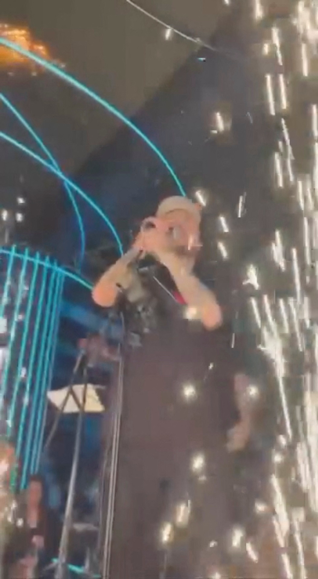 Fireworks exploding during a concert as fire spreads on the roof.