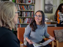 Montclair Public Health student Veronica Paniagua discusses Aging in Place volunteer program with a senior community member.